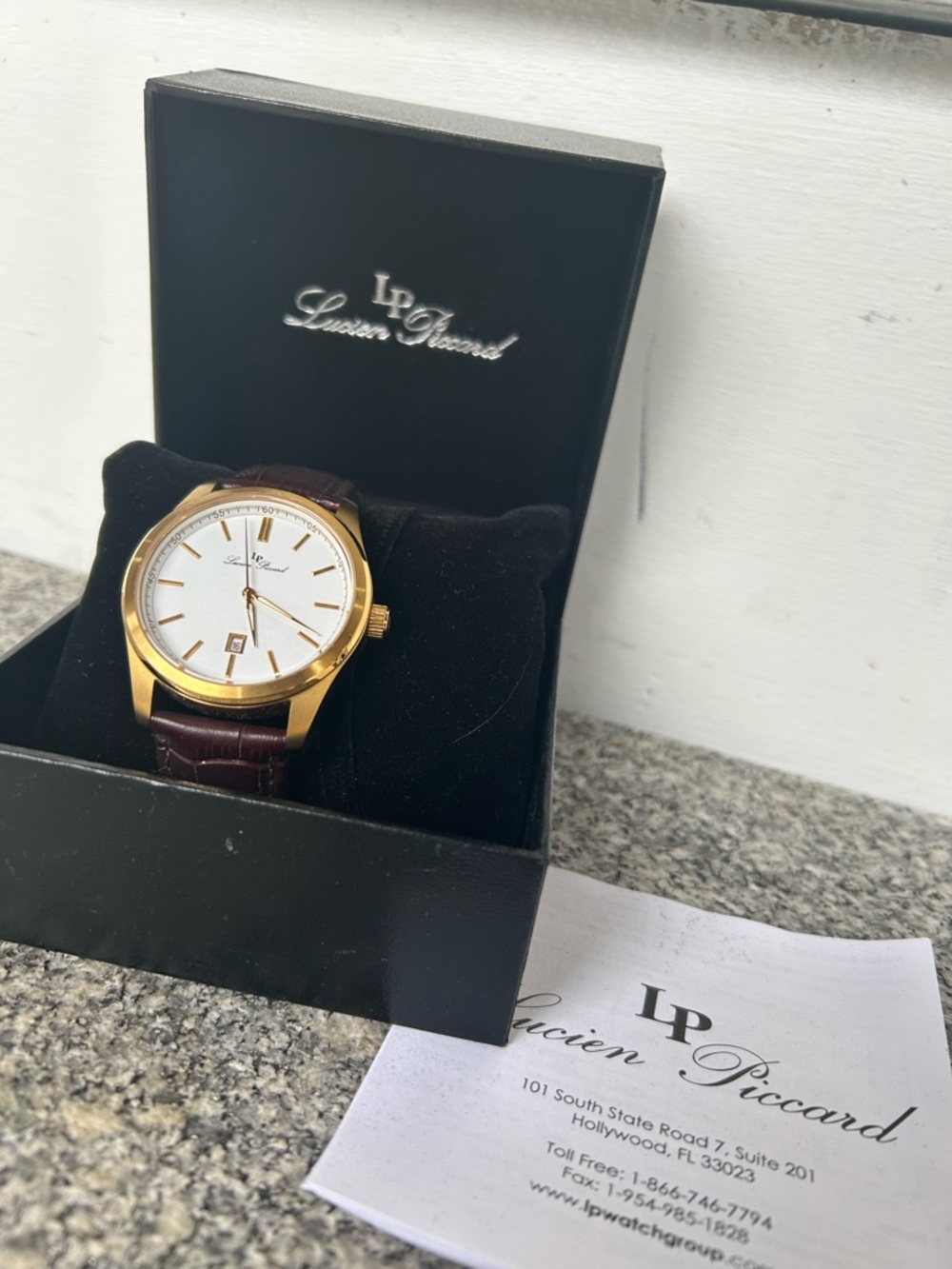 Lucien Piccard Gold Tone Case With Brown Strap And White Dial Accents